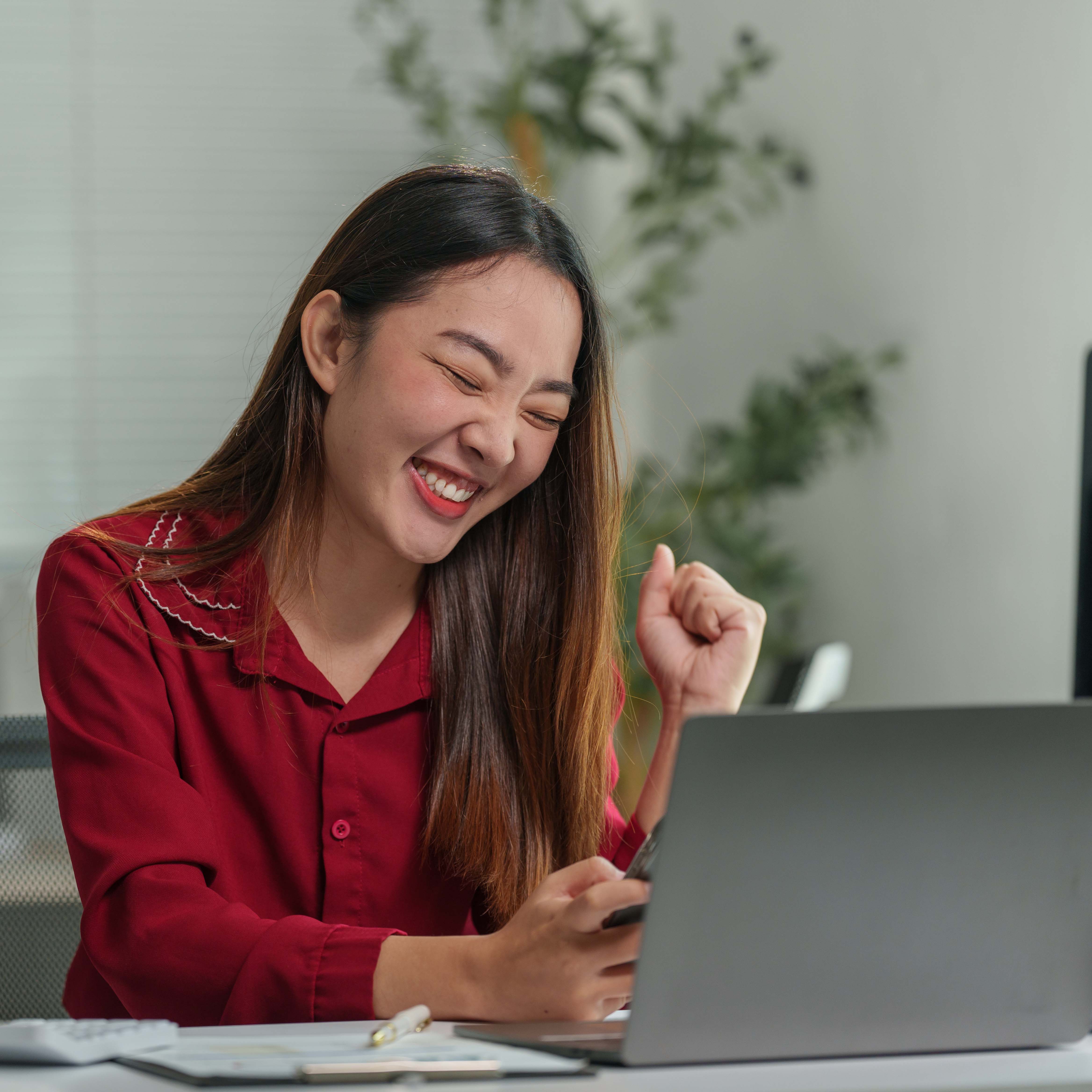 Woman excitedly looking at her phone