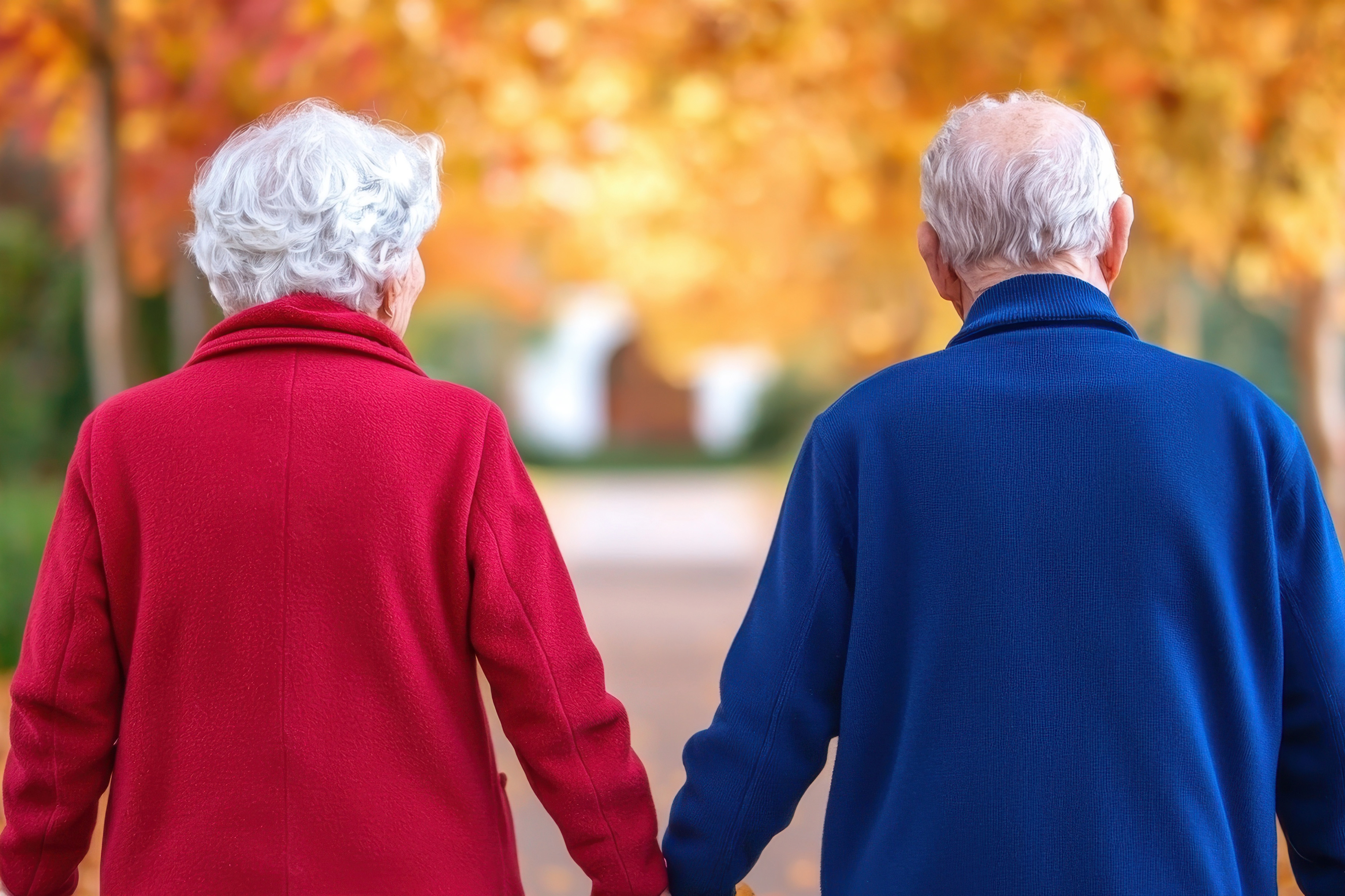 Senior couple walking outside in fall
