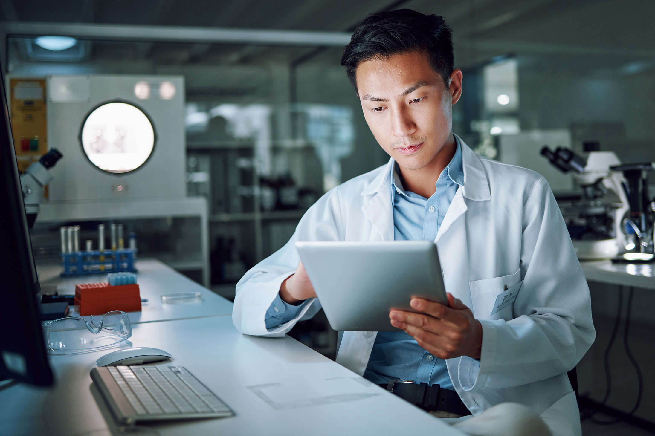 Man in a lab reading a report