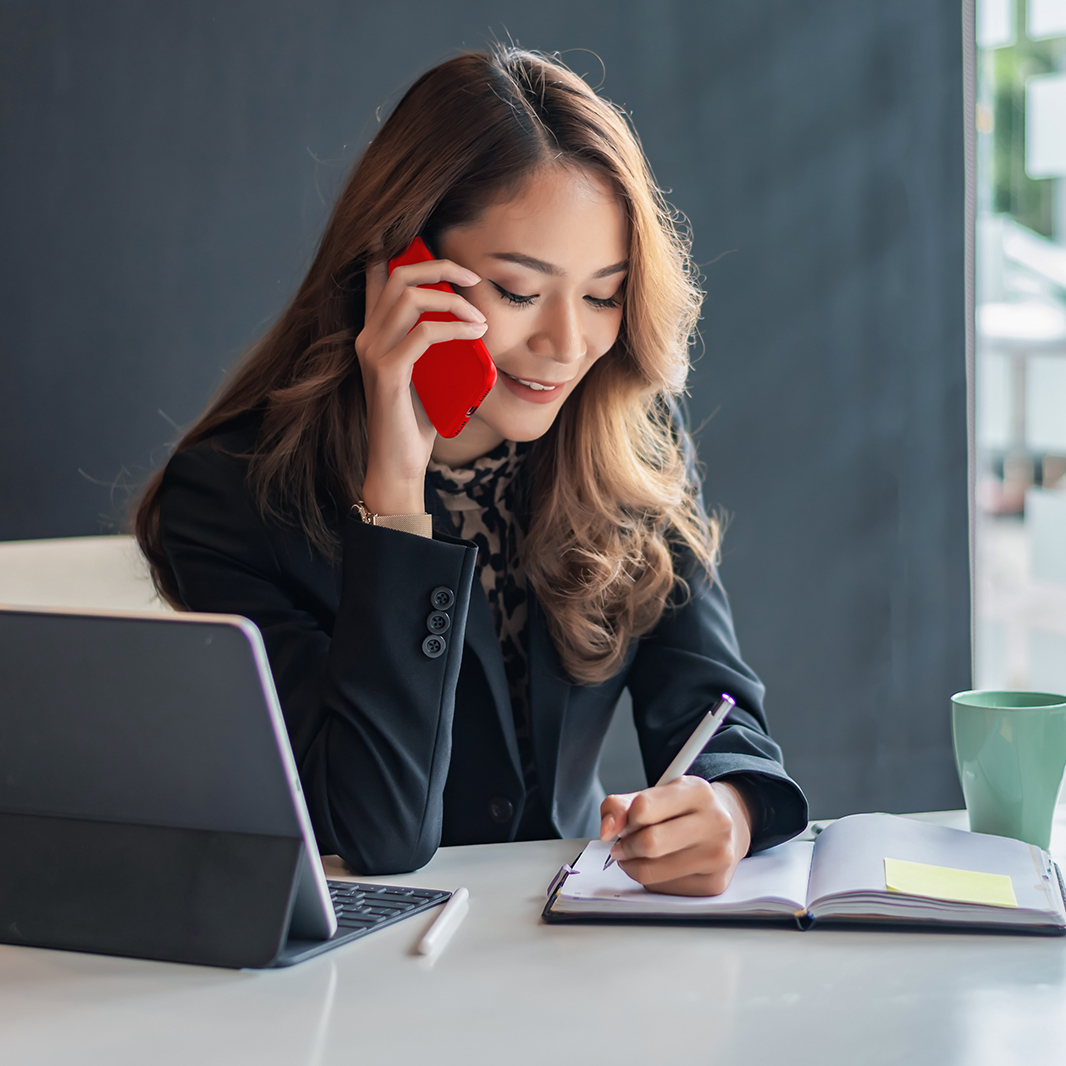 Woman on the phone taking notes