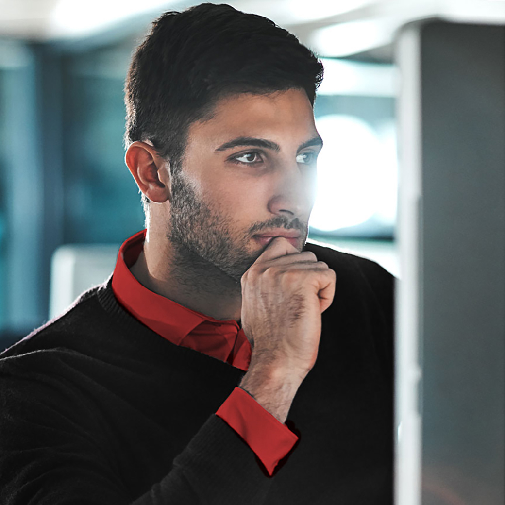 Fraud investigator looking at a file on his computer