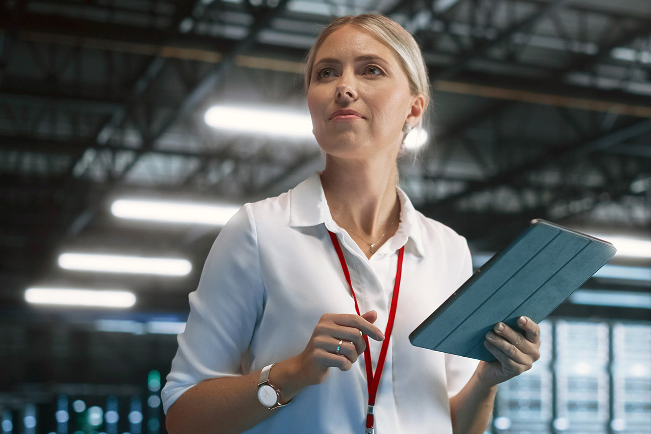 Woman with tablet in server room