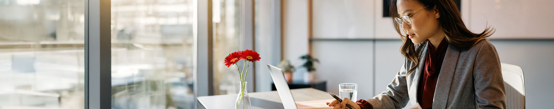 A woman gazes thoughtfully at a claims record