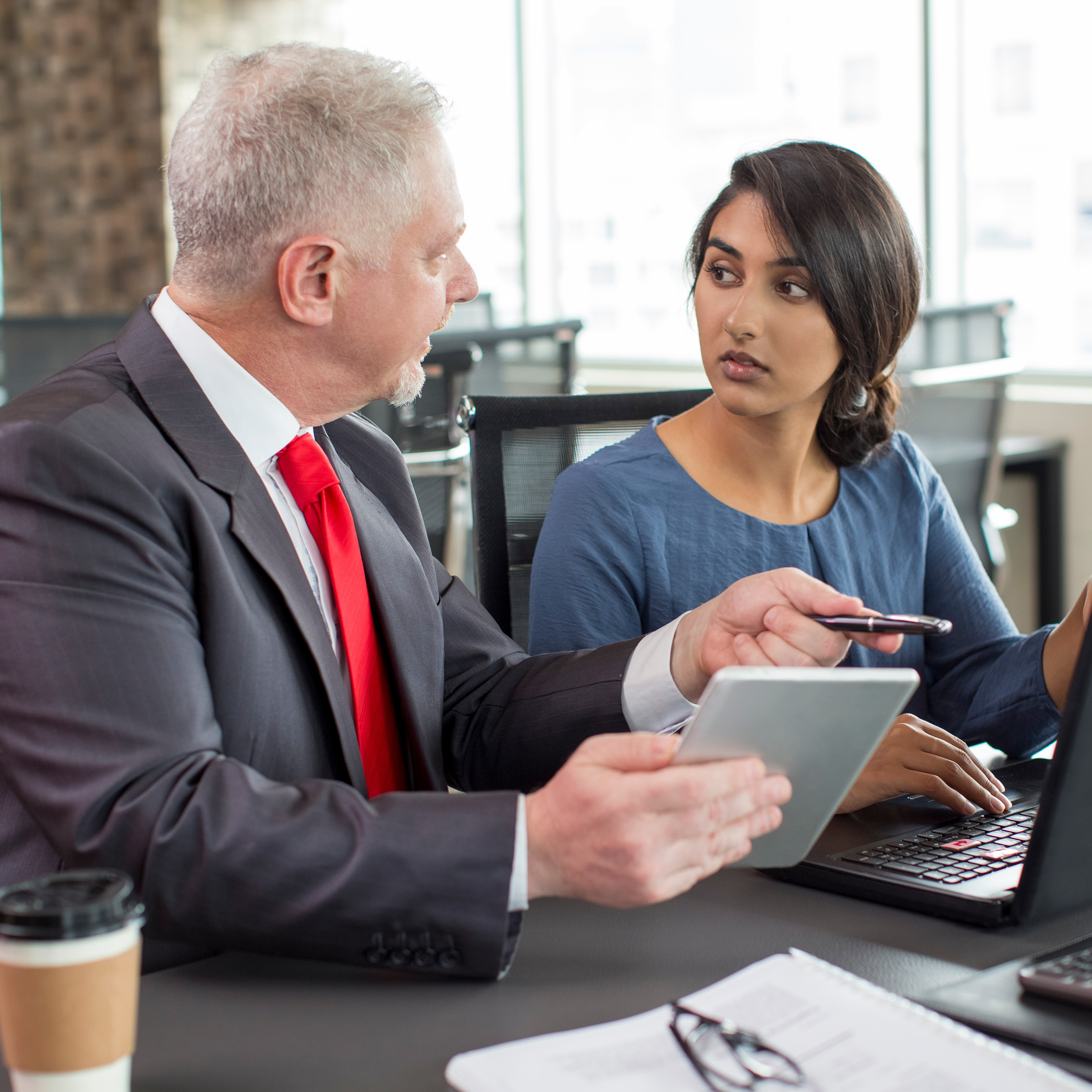 Two people talking about a report