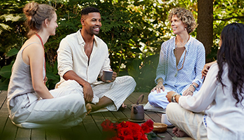 Four people sitting on a deck