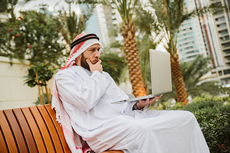Middle Eastern man with a laptop