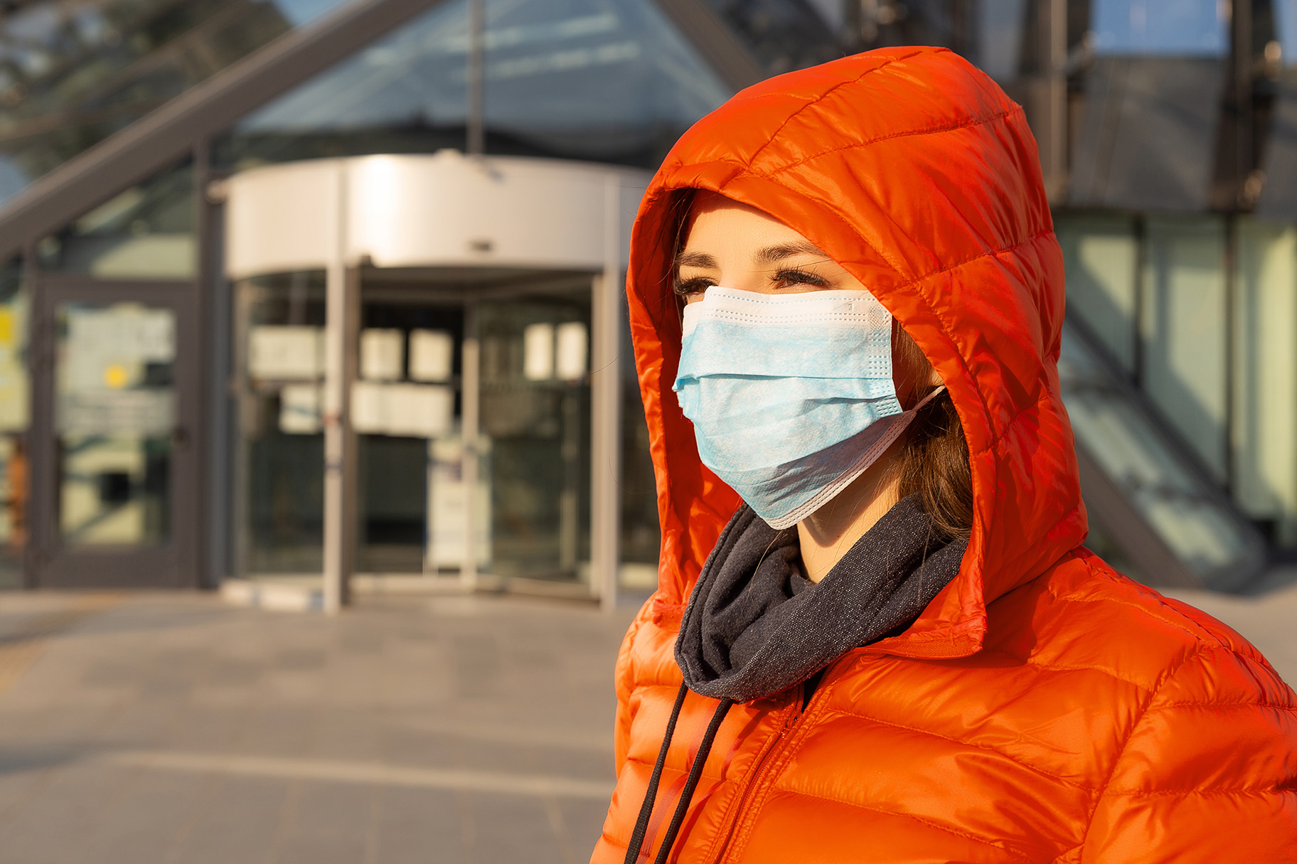 Person in red outside wearing mask