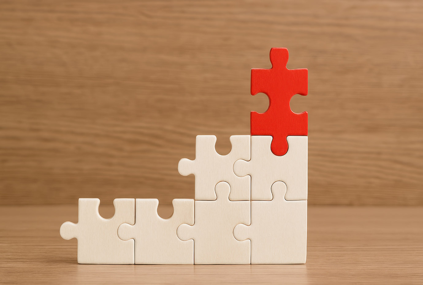 Red puzzle piece on white puzzle built vertically