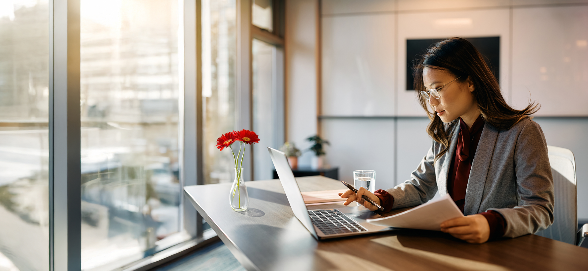 A woman looks thoughtfully through an attending physician statement