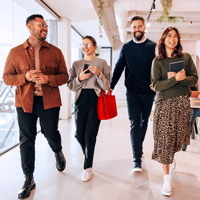 A group of young professionals walk down a hall together